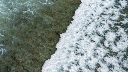 Sticker - Aerial view of the huge waves crossing the clear tranquil surface of the water