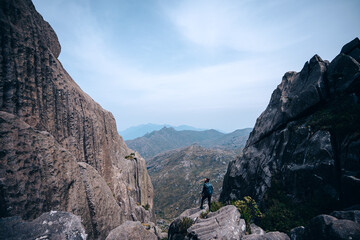 Poster - View of rocky mountains with plants against a gray sky in Itatiaia National Park, Brazil