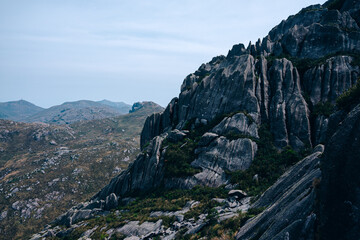 Poster - View of rocky mountains with plants against a gray sky in Itatiaia National Park, Brazil