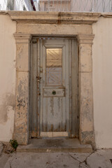 Vertical shot of the entry of an old building in Crete