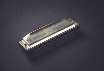 Wall Mural - Vintage harmonica isolated on black