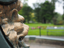 Closeup Of A Lion Head Statue On A Park Background