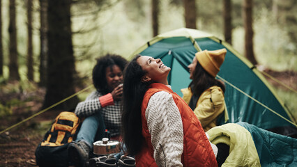 Laughing friends camping in the woods