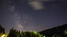 Low Angle Shot Of The Beautiful Phenomenon Milky Way With The Stars In The Sky And Trees Down Below
