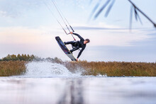 Kiteboarding Athlete Having Session In The Water Jumping And Doing Stylish Moves