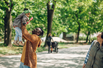 Wall Mural - African american father spending time with his daughter in the park