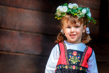 Adorable little girl in Swedish traditional clothes during Midsommar festival