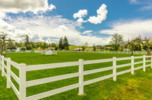 Typical White Wooden Fence In Farmland. Spring In Rural Area.
