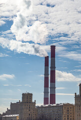 Poster - CHP in the city. Smoke rises into the sky from the heat pipes of the power plant. Pipe of combined heat and power plant CHP or cogeneration against background of multi-storey residential buildings