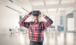 © adam121 - Concept of modern entertaining technologies with man wearing virtual reality mask