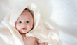 © otello-stpdc - Adorable, Asian newborn laying with white blanket on whute bed in bedroom. Baby boy looking at camera with happy face. Little innocent new infant child in first day of life. Mother day concept.