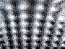 The Surface Of The Silver Reflector Reflects Light, The Surface Pattern Is A Small Rectangular Grid.