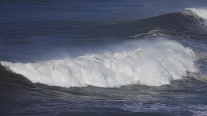 Wall Mural - Large foamy wave rolling on the surface of a stormy ocean, 4k