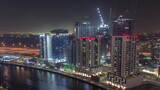 Fototapeta Nowy Jork - Towers at the Business Bay aerial night timelapse in Dubai, United Arab Emirates