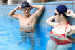 © Tom Wang - Young couple swimmers preparing to race at the swimming pool