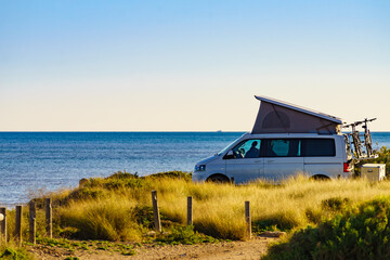 Wall Mural - Camper van with roof top tent camp on beach