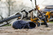 © glebcallfives - Close-up of a sneakers on the road near bicycle after car accident.