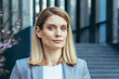 © Liubomir - Close-up photo of a confident business woman looking at the camera thoughtfully and seriously