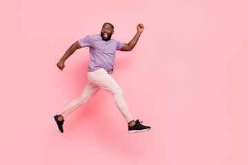 Wall Mural - Full length body size view of attractive cheerful guy jumping running flight isolated over pink pastel color background