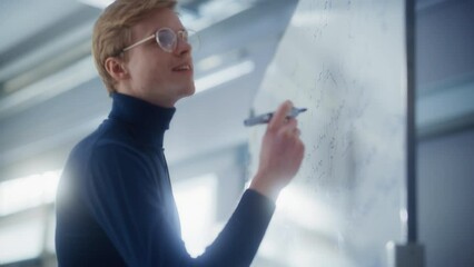 Wall Mural - Young Male Scientist Solving Problems and Discovering New while Using Whiteboard. Science, Conceptuality and Breakthrough in Science Concept