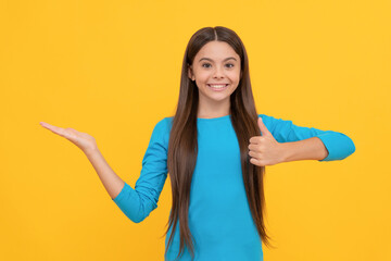 Poster - happy pretty look of young girl. face portrait of child on yellow background.