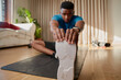 African American stretching hamstring at home 