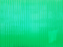 Bright Green Metal Sheet Wall With Corrugated Pattern Texture Use As Background. Gradient Green Turquoise Metallic Or Zinc Wall Background For Industrial, Fantasy Concept.