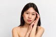 © Prostock-studio - Beauty portrait of young Asian woman touching her clean face