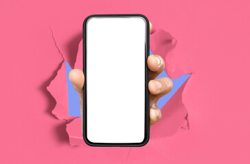 person showing white empty smartphone screen breaking through paper