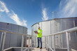 © เลิศลักษณ์ ทิพชัย - A male industrial engineer is working on designing and managing production in an engineering plant. Utilities and utilities Sewers and central wastewater treatment plants