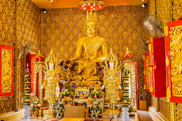 Wall Mural - Nakhon Nayok, Thailand - April, 24, 2022 : Golden buddha statue in church of Maniwong Temple at Nakhon Nayok, Thailand.