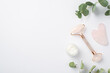 Top view photo of eucalyptus cream bottle rose quartz roller and gua sha on isolated white background with copyspace