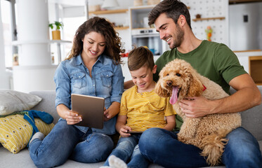 Wall Mural - Happy family with modern devices and dog having fun, playing at home