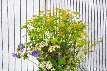 Wall Mural - Beautiful colorful blooming wild flowers on a textile background.