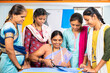 © WESTOCK - trainer explaining or guiding to cut clothes to group of women students at training center - concept of learning, empowerment and employment