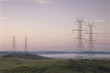 © SuperStock - Electricity pylons in a field