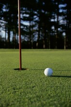 Close-up Of A Golf Ball Near The Hole
