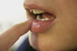 © SuperStock - Close-up of a person's finger on their lips