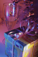 Close-up Of A Wrapped Gift And A Champagne Glass