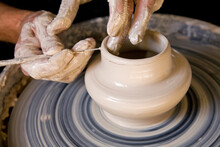 Person's Hands Making Pottery