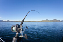 Fishing Rod With Mountain Range In The Background, British Columbia, Canada