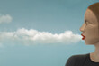 © Cristina Conti - surreal woman creates clouds by blowing from her mouth