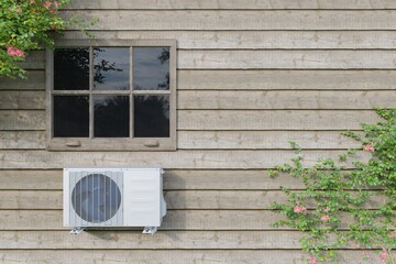 outdoor air conditioner unit on a wooden house with a window. 3d