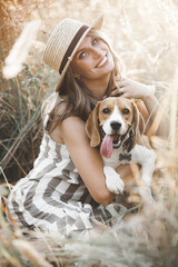 Wall Mural - Attractiive young woman outdoors with her pet. Owner and dog together. Friends forever. Lady and beagle