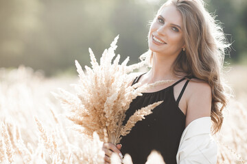 Wall Mural - Beautiful blond woman closeup portrait outdoors. Smiling face. Lovely lady at summer background. Emotional female outdoors.