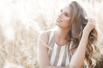 Wall Mural - Beautiful blond woman closeup portrait outdoors. Smiling face. Lovely lady at summer background. Emotional female outdoors.