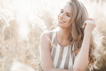 Wall Mural - Beautiful blond woman closeup portrait outdoors. Smiling face. Lovely lady at summer background. Emotional female outdoors.