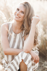 Wall Mural - Beautiful blond woman closeup portrait outdoors. Smiling face. Lovely lady at summer background. Emotional female outdoors.