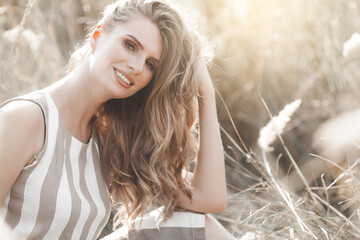 Wall Mural - Beautiful blond woman closeup portrait outdoors. Smiling face. Lovely lady at summer background. Emotional female outdoors.