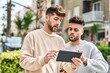 © Krakenimages.com - Young couple using touchpad standing together at street